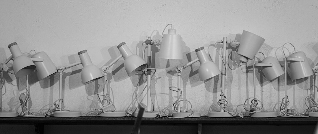 Open books and a lamp on a study desk