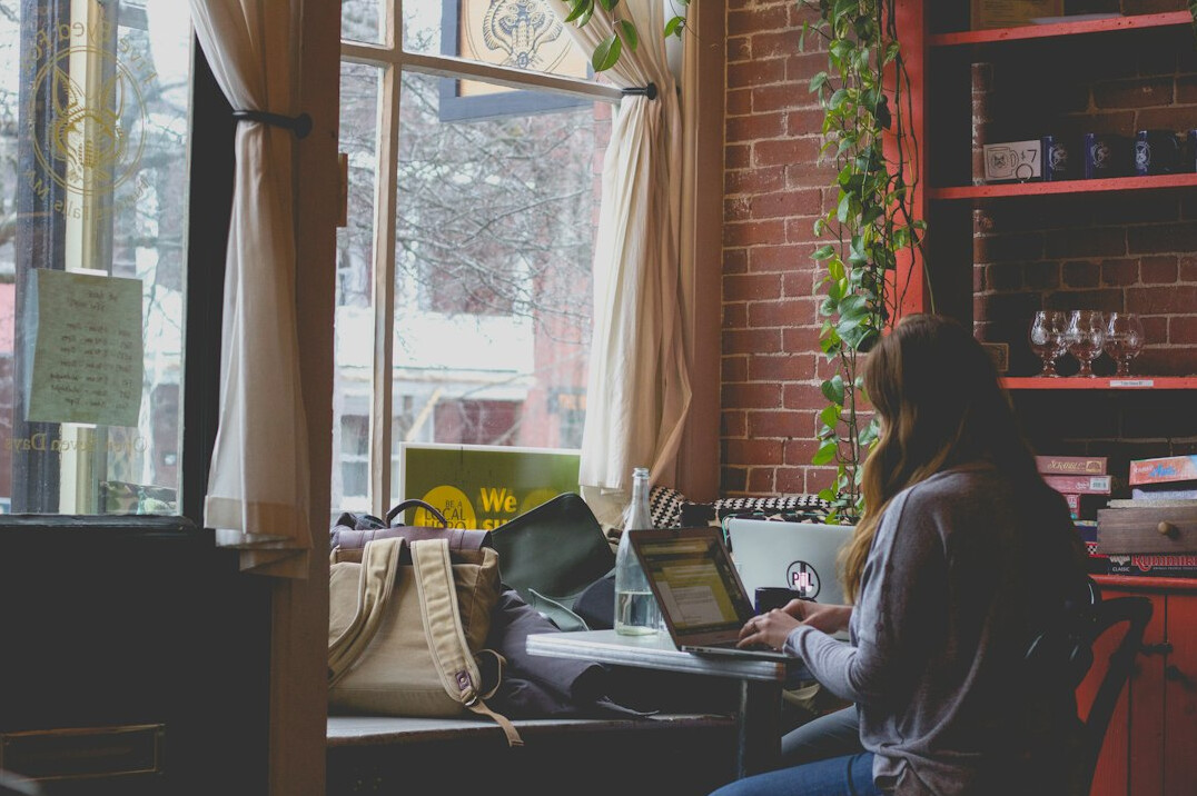 woman studying with laptop in cafe